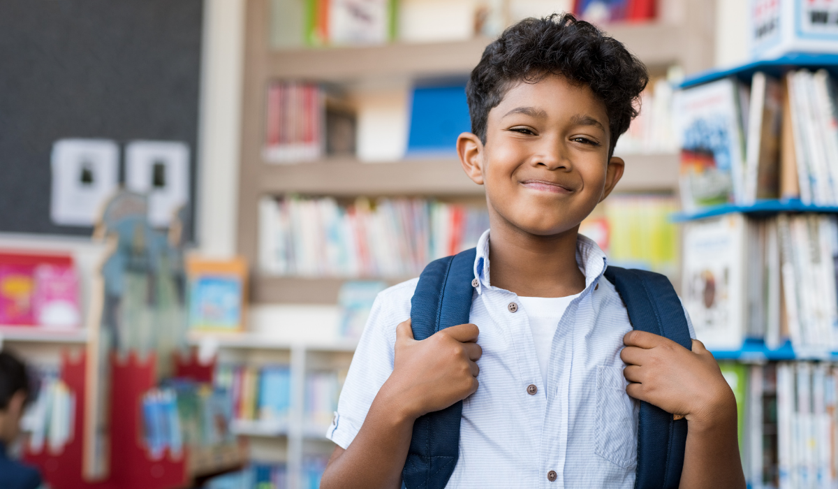 kid smiling at library