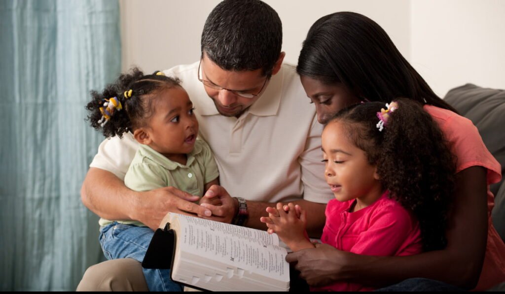 family praying and reading the bible (1)