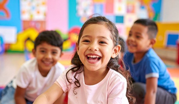 little kids smiling in classroom