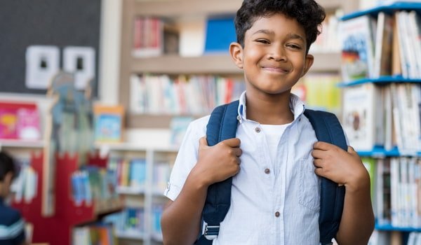 student smiling in library